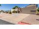 View of home featuring a two-car garage and charming landscaping at 619 E Jensen St # 34, Mesa, AZ 85203