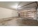Spacious garage with storage shelves, an automatic garage door, and a door to the house at 619 E Jensen St # 34, Mesa, AZ 85203