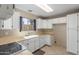 Bright kitchen features white cabinetry, laminate countertops and a large window at 619 E Jensen St # 34, Mesa, AZ 85203