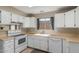 Bright kitchen features white cabinetry, laminate countertops and a large window at 619 E Jensen St # 34, Mesa, AZ 85203