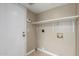 This laundry room offers a storage shelf above the washer and dryer hookups at 619 E Jensen St # 34, Mesa, AZ 85203