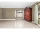 Neutral living area featuring tile flooring, a bay window, and a decorative armoire at 619 E Jensen St # 34, Mesa, AZ 85203