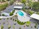 Aerial view of backyard pool, outdoor kitchen and seating area surrounded by expertly manicured grounds at 6310 E Desert Cove Ave, Scottsdale, AZ 85254