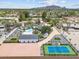 Stunning aerial view of a home featuring a pool, tennis court, desert landscaping, and mountain views at 6310 E Desert Cove Ave, Scottsdale, AZ 85254