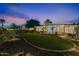 Expansive backyard with lush lawn, mature trees, and thoughtfully designed landscaping for serene outdoor living at 6310 E Desert Cove Ave, Scottsdale, AZ 85254