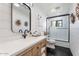Bright bathroom with shiplap walls, wooden vanity, and modern finishes at 6310 E Desert Cove Ave, Scottsdale, AZ 85254