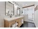 Bright bathroom features a double vanity, walk-in shower, and modern finishes at 6310 E Desert Cove Ave, Scottsdale, AZ 85254