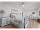 Cozy bedroom with wood floors, a metal frame bed, and neutral decor at 6310 E Desert Cove Ave, Scottsdale, AZ 85254