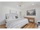 Neutral bedroom with hardwood floors, a metal frame bed, and decorative artwork at 6310 E Desert Cove Ave, Scottsdale, AZ 85254