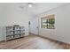 Bright bedroom with wood floors and window, featuring a white ceiling fan and metal storage drawers at 6310 E Desert Cove Ave, Scottsdale, AZ 85254