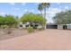 Attractive single-story home featuring well-manicured landscaping, mature trees, and a spacious driveway at 6310 E Desert Cove Ave, Scottsdale, AZ 85254