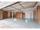 Spacious garage with epoxy floors, built-in cabinets, storage solutions, a refrigerator, and a well-organized shoe rack at 6310 E Desert Cove Ave, Scottsdale, AZ 85254