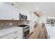 A bright kitchen featuring stainless steel appliances, subway tile backsplash, and open access to living area at 6310 E Desert Cove Ave, Scottsdale, AZ 85254