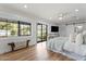 Bright main bedroom with hardwood floors, large windows, and backyard access at 6310 E Desert Cove Ave, Scottsdale, AZ 85254