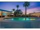 Inviting pool with lush landscaping and lighting, creating a tranquil atmosphere at 6310 E Desert Cove Ave, Scottsdale, AZ 85254