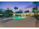 Stunning pool with diving board surrounded by lush landscaping and outdoor lighting at 6310 E Desert Cove Ave, Scottsdale, AZ 85254