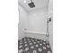 Modern walk-in shower featuring black and white mosaic tile and a built-in bench at 6310 E Desert Cove Ave, Scottsdale, AZ 85254