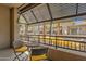 Inviting balcony featuring comfortable seating with views of palm trees and building facade at 6565 E Thomas Rd # 1096, Scottsdale, AZ 85251
