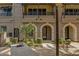 Well-maintained building featuring archways, private balconies, and neatly landscaped grounds at 6565 E Thomas Rd # 1096, Scottsdale, AZ 85251