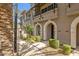 Attractive building exterior with manicured landscaping and arched entryways at 6565 E Thomas Rd # 1096, Scottsdale, AZ 85251