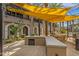 Outdoor community space with grilling station, tables, and shade structures for resident enjoyment at 6565 E Thomas Rd # 1096, Scottsdale, AZ 85251
