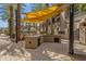 Outdoor community area with grilling station and seating under a shaded pergola at 6565 E Thomas Rd # 1096, Scottsdale, AZ 85251