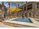 Inviting community pool area with lounge seating, grilling stations and shade, perfect for outdoor relaxation at 6565 E Thomas Rd # 1096, Scottsdale, AZ 85251