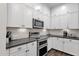 Elegant kitchen with white cabinets, stainless steel appliances, and sleek countertops at 6565 E Thomas Rd # 1096, Scottsdale, AZ 85251