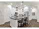 Modern kitchen with white cabinets, stainless steel appliances, and a stylish breakfast bar at 6565 E Thomas Rd # 1096, Scottsdale, AZ 85251