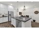 Modern kitchen island boasts stainless steel appliances and ample counter space with open dining area at 6565 E Thomas Rd # 1096, Scottsdale, AZ 85251