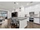 Modern kitchen featuring a large island with seating and pendant lighting that opens to the living area at 6565 E Thomas Rd # 1096, Scottsdale, AZ 85251