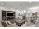 Open-concept living room seamlessly connects to a modern kitchen with dark wood-look floors at 6565 E Thomas Rd # 1096, Scottsdale, AZ 85251