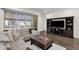 Living room with stylish decor, large TV, and a sliding glass door to a balcony at 6565 E Thomas Rd # 1096, Scottsdale, AZ 85251