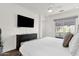 Bedroom with a view, full bed, dresser, and ceiling fan at 6565 E Thomas Rd # 1096, Scottsdale, AZ 85251