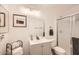Clean bathroom with modern vanity, framed mirror, and glass-enclosed shower at 7222 W Maryland Ave, Glendale, AZ 85303