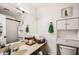 Bright bathroom with a large mirror, vanity, and a cabinet for storage at 7222 W Maryland Ave, Glendale, AZ 85303