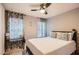 Comfortable bedroom featuring neutral walls, natural light, and ceiling fan at 7222 W Maryland Ave, Glendale, AZ 85303