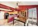 Inviting dining area featuring a wooden table, decorative hutch, and red accent wall at 7222 W Maryland Ave, Glendale, AZ 85303