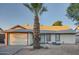 Charming single-story home featuring a low maintenance desert front yard, palm tree, and attached garage at 7222 W Maryland Ave, Glendale, AZ 85303