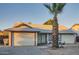 Single-story home featuring an attached garage, low maintenance desert front yard, and a mature palm tree at 7222 W Maryland Ave, Glendale, AZ 85303