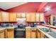 Efficient kitchen with updated appliances, wood cabinets, and ample counter space at 7222 W Maryland Ave, Glendale, AZ 85303