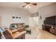 Open-concept living room with a vaulted ceiling, tile flooring, comfortable seating, and backyard views at 7222 W Maryland Ave, Glendale, AZ 85303