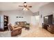 Cozy living room featuring a vaulted ceiling, tile flooring, and comfortable leather furniture at 7222 W Maryland Ave, Glendale, AZ 85303