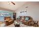 Comfortable living room featuring tile flooring, a vaulted ceiling, and comfortable leather furniture at 7222 W Maryland Ave, Glendale, AZ 85303