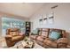 Spacious living room featuring vaulted ceiling, tile flooring, comfortable seating, and ample natural light at 7222 W Maryland Ave, Glendale, AZ 85303