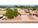Charming home with desert landscaping, mature tree, and a two-car garage at 7833 S Kenneth Pl, Tempe, AZ 85284