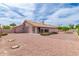 Spacious backyard with desert landscaping and covered patio at 7833 S Kenneth Pl, Tempe, AZ 85284