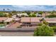 Aerial view of backyard, including a covered patio area, desert landscaping, and mature trees at 7833 S Kenneth Pl, Tempe, AZ 85284