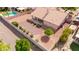 Aerial view of home's backyard, showcasing a covered patio, block wall, desert landscaping and inviting spaces at 7833 S Kenneth Pl, Tempe, AZ 85284