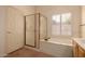Bathroom with a shower over the bath and plantation shutters at 7833 S Kenneth Pl, Tempe, AZ 85284
